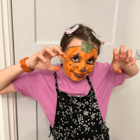 girl with pumpkin face paint